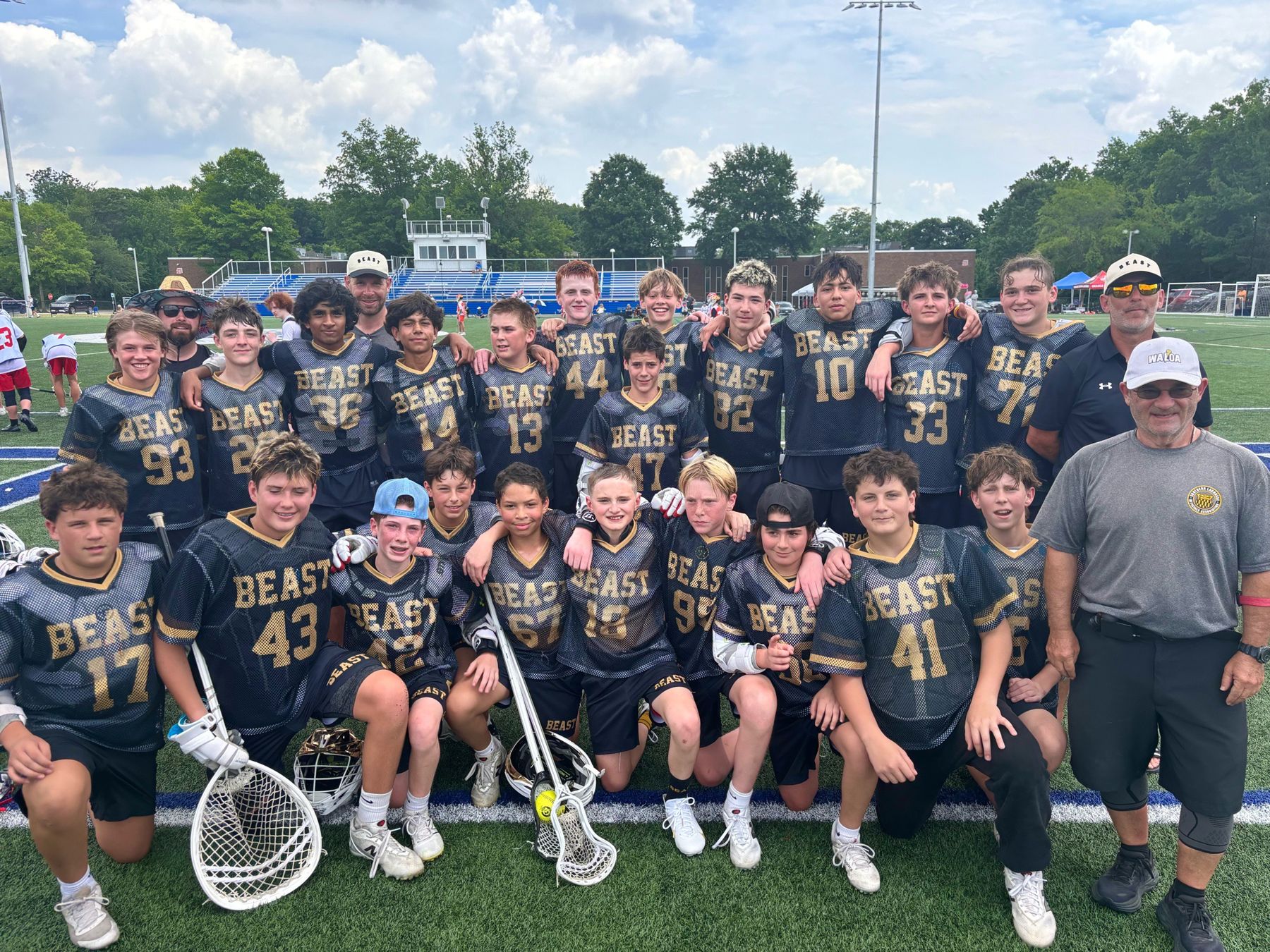 A BEAST travel team in black and gold mesh jerseys after a tournament game
