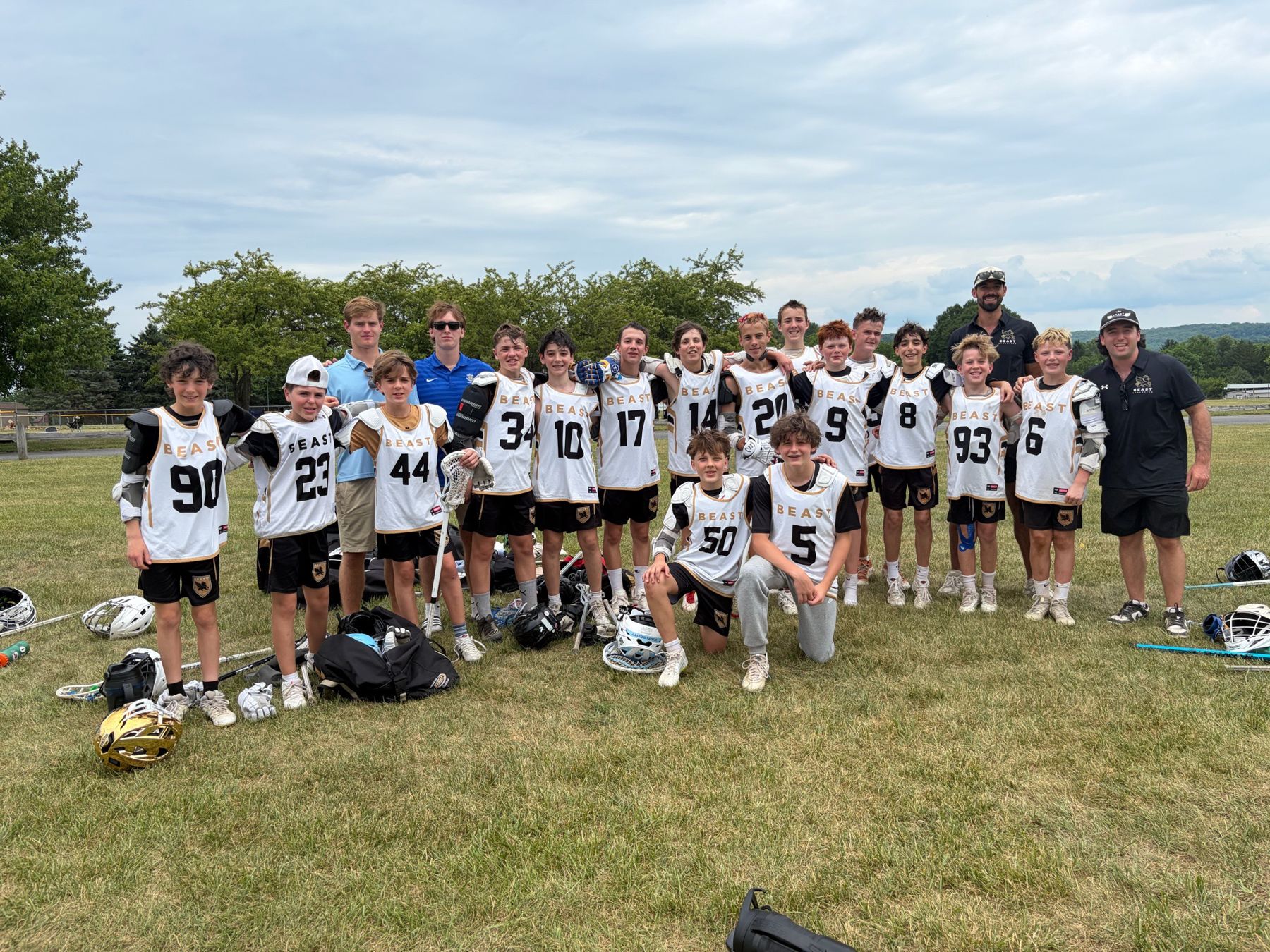 A BEAST team in white game pinnies with coaches